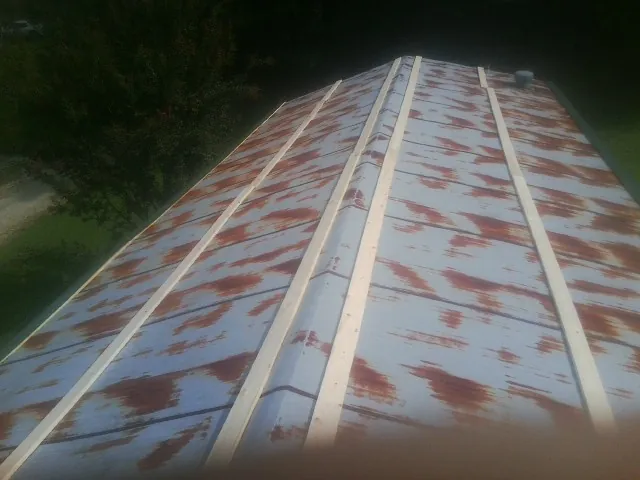 Rusted metal roof panels with new wood purlins before replacement — Storm Damage Roof Repair in Olema by Roofing Brothers