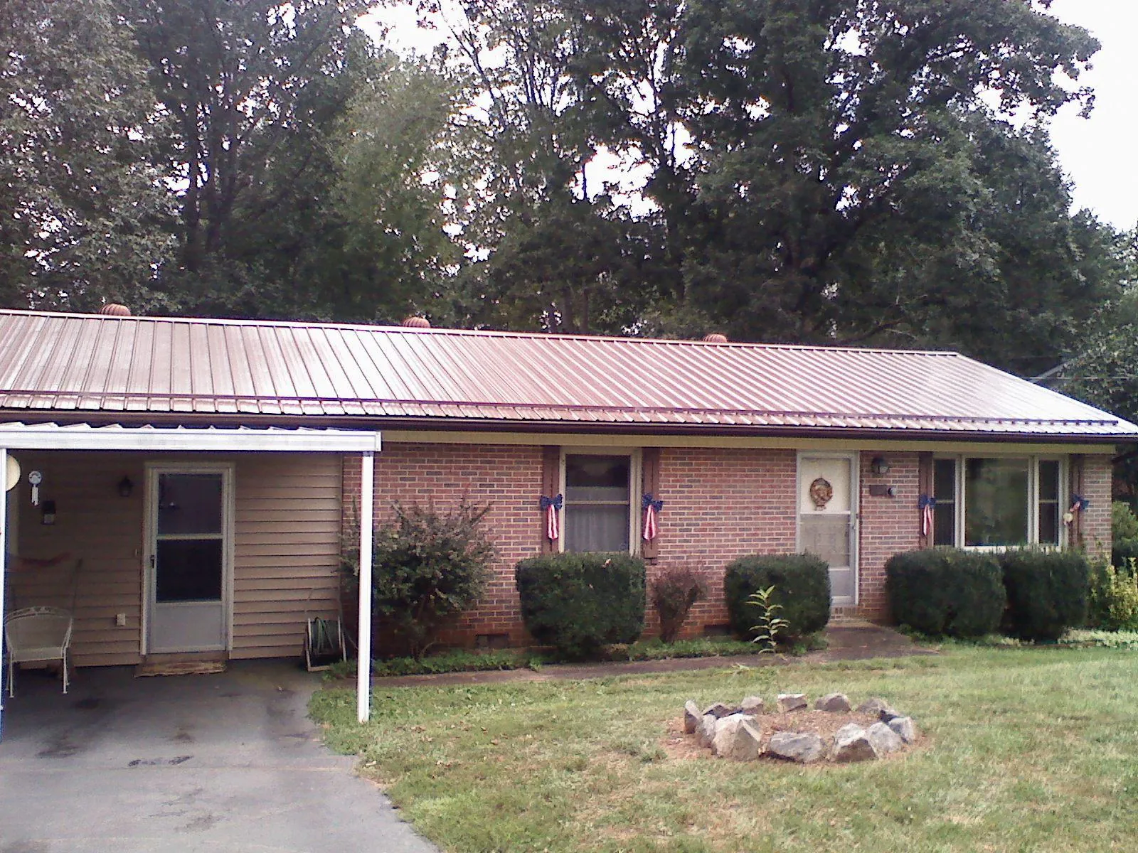 Bronze metal roof and carport on a brick ranch home — Roof Repair work by our crew in Olema